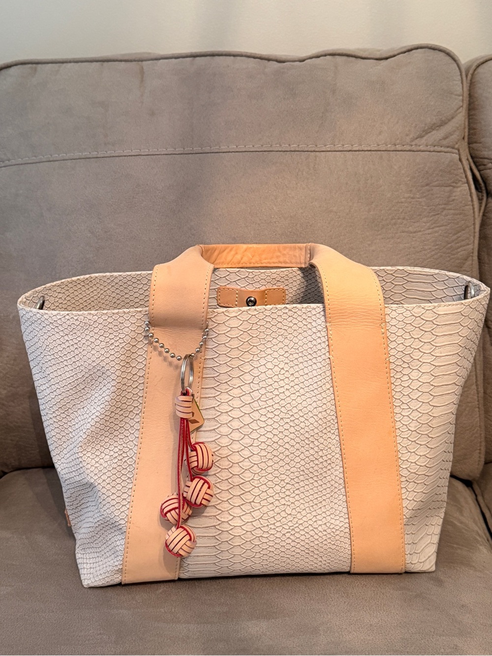 Consuela Thunderbird Carryall Cream Textured Tote with Tan Straps and Red Tassel